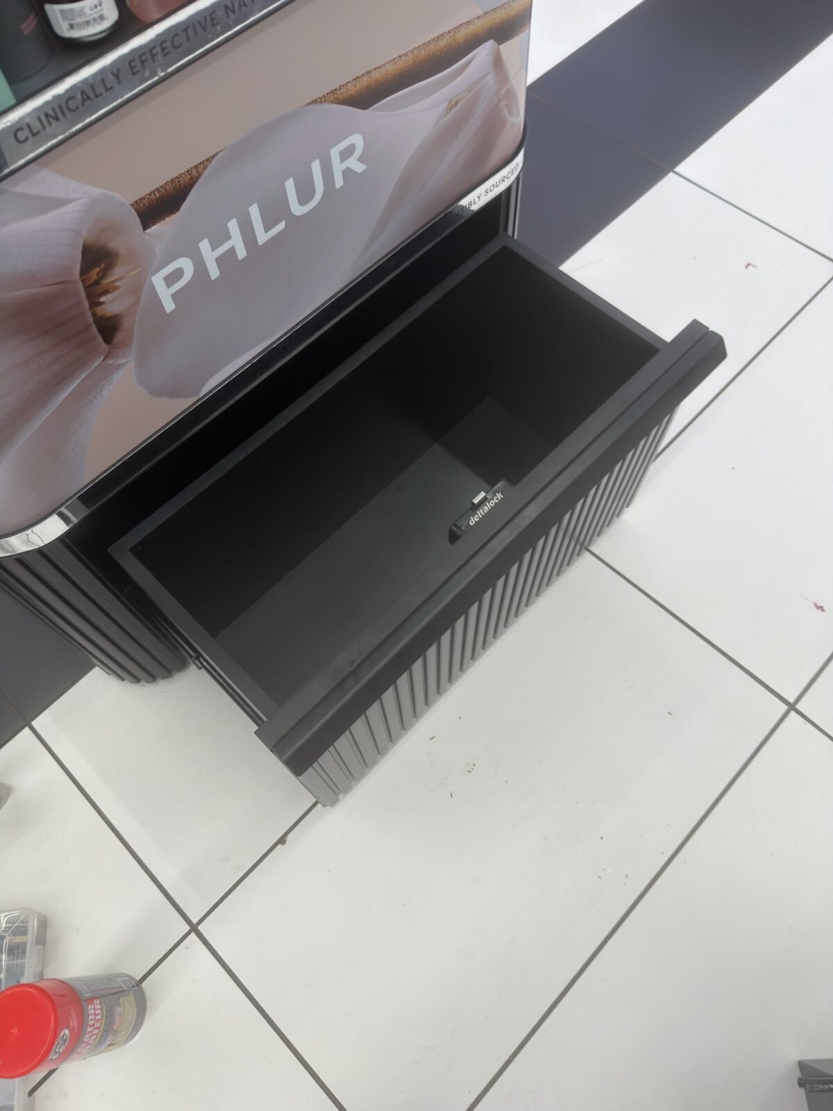 Display cabinet drawer with lock repaired at a retail fixture