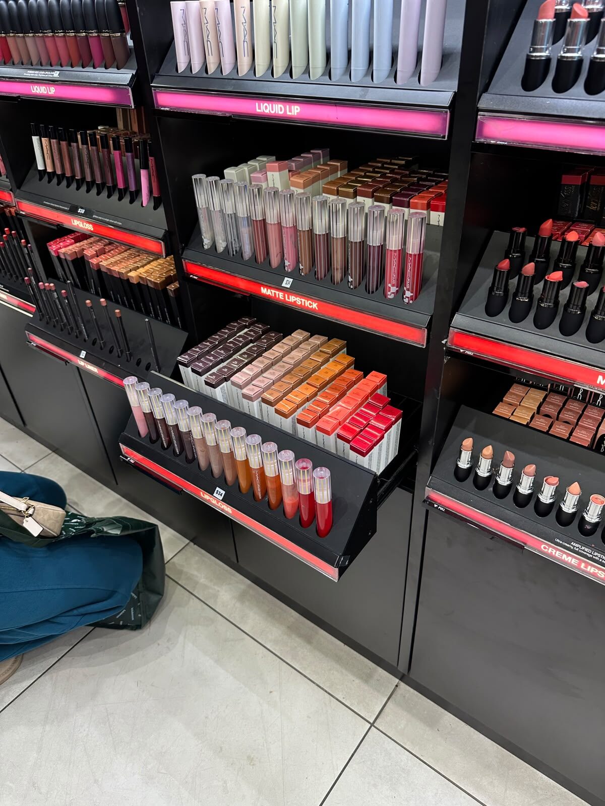 Pull-out cosmetics display tray serviced and re-aligned
