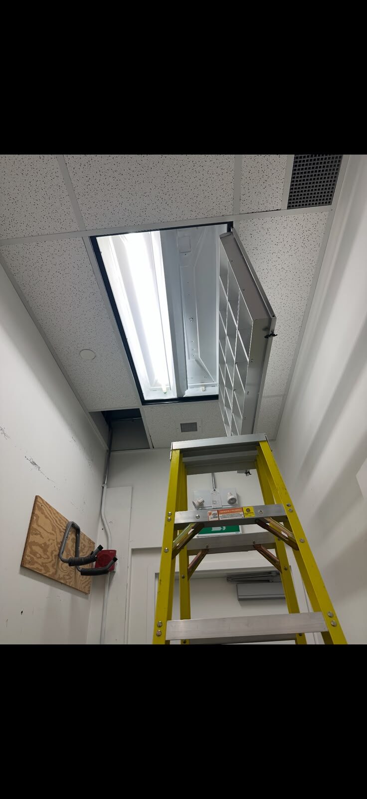 Ceiling fixture and storage shelving installation from a ladder